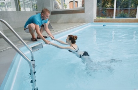 Young beauty takes a dip in an indoor pool before sex on a lounge chair