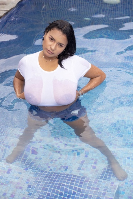 In a swimming pool, MILF Kim Beltran exposes her massive breast tissue.