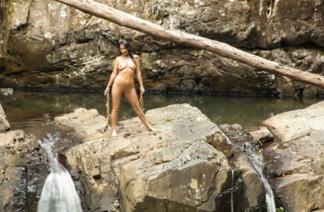 Brunette Amateur Roxeanne Models A Revealing Bikini On Boulders Near Water