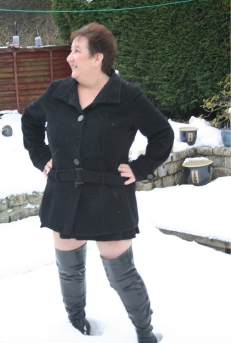 An aged UK fatty named Kinky Carol wears them on snow-covered ground, stripping into over-knit boots.