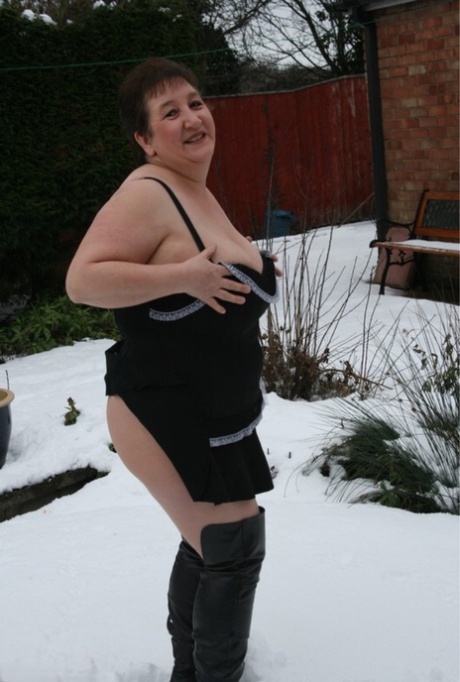 The UK's Kinky Carol, who is aged fatty, seizes over the knee boots on snowy terrain.