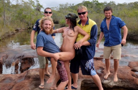 The naked Roxeanne is groped by several men before she enjoys a beer.