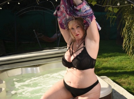 Mature Blonde Fatty Melody Disrobes Before Getting In An Outdoor Hot Tub