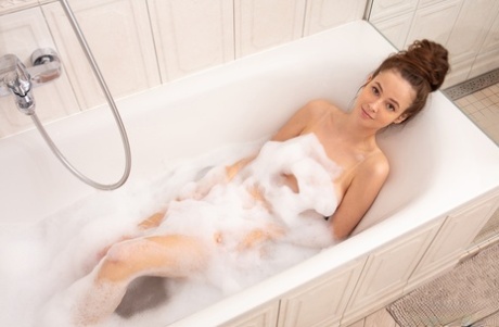 Teen sexy charmer goes for foam bath and seduces you with her curves.
