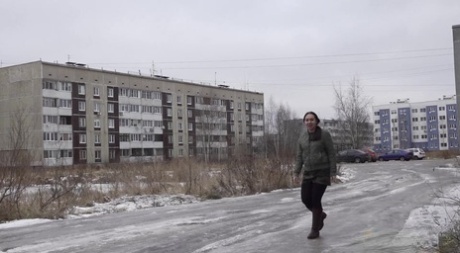 A pissycat girl named Anya ducks behind an apartment building.