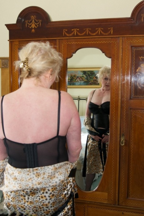 Blonde Granny Admires Herself In A Mirror While Wearing Lingerie And Nylons