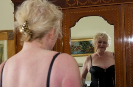 Blonde Granny Admires Herself In A Mirror While Wearing Lingerie And Nylons