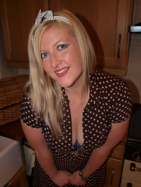 Samantha, a blonde who is overweight and has been disrobing in a kitchen area, spreads her penis around the room.