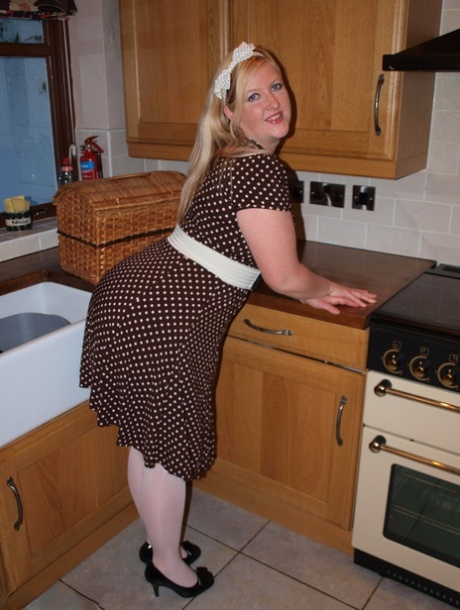 Samantha, who is overweight and blonde, grabs her penis in a kitchen towel before disrobing and spreading it throughout the bathroom.