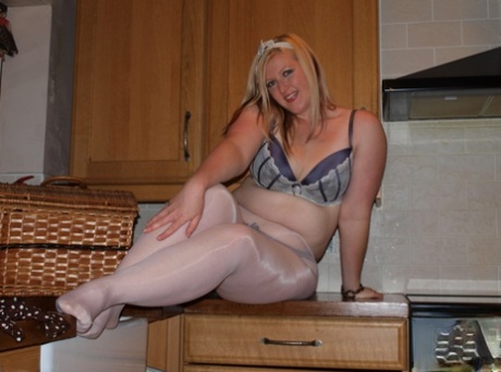 Following her abduction in a kitchen, Samantha the blonde who is overweight spreads her penis over herself to reveal her body.
