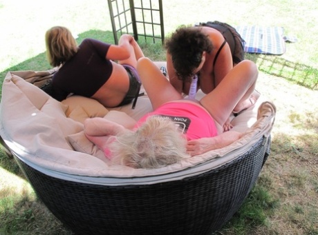 Some older amateurs have a lesbian threesome on the furniture in their backyard.