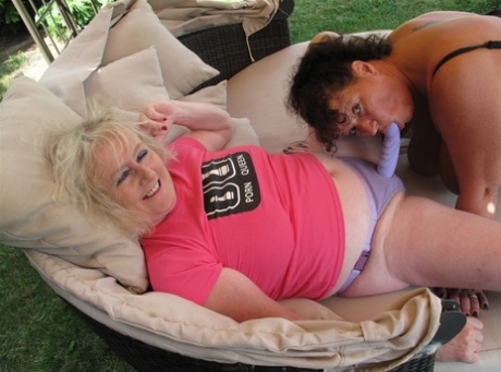 The backyard furniture of older amateurs is decorated with a lesbian threesome.