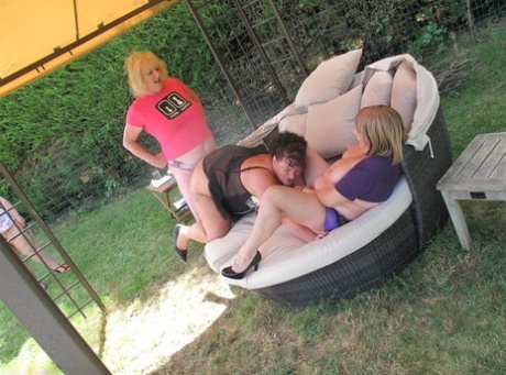 An old set of backyard furniture is being used by older amateurs to house a lesbian threesome.