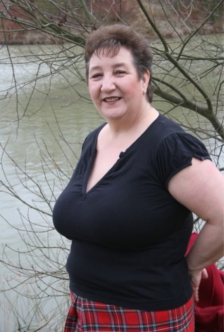 In her plaid skirt, Kinky Carol the fat UK woman strips off her shirt just before the water.