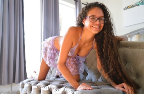 Angel, a first-time user with long hair, uses a pink dildo to perform her cunt.