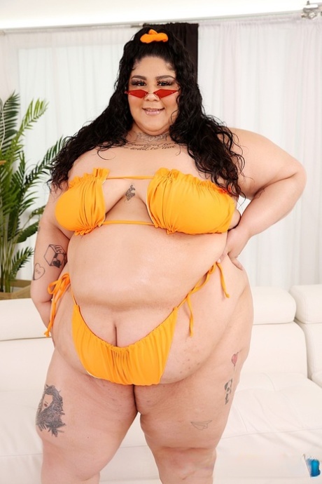 Exposed: Brunette SSBBW Crystal Blue tote shows off her bikini as she gets completely naked again.