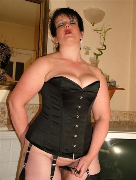 British Pumper Double Dee Models A Back Laced Corset In Nylons And Heels