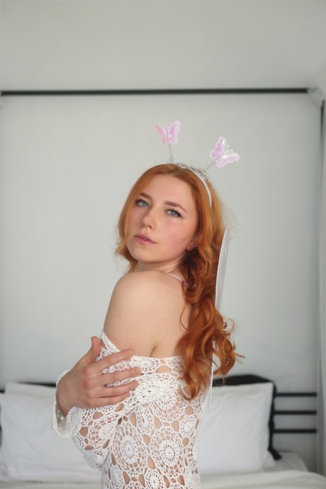 As she gets nude on top of her bed, young redhead Ana does it in a cute way.