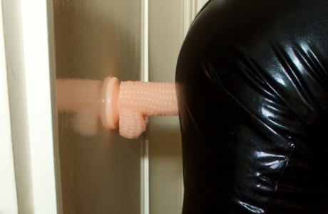 Latex wears: Old British woman Speedy Bee uses a suction dildo to pleasure herself.