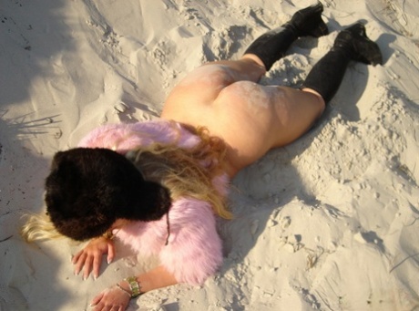 Short and smoky curly named Curvy Meile displays her pussies and torn tits on a sandy bank.