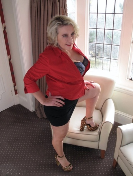 When playing as an upskirt solo, a mature blonde pulls off a black miniskirt.