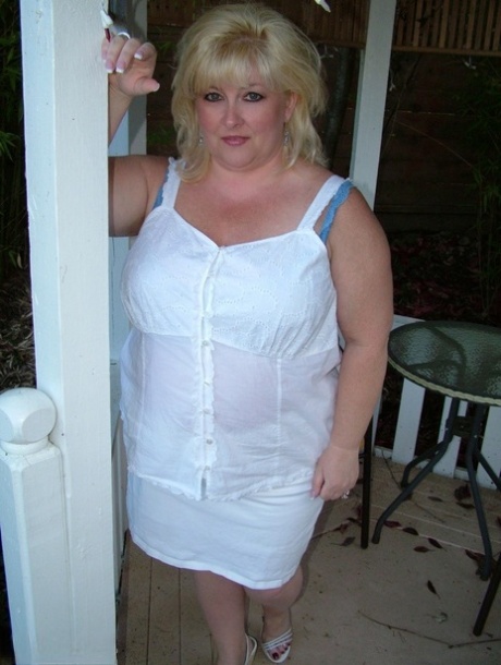 Exposed, blonde blonde Taffy Spanx takes to the patio in public before masturbating.