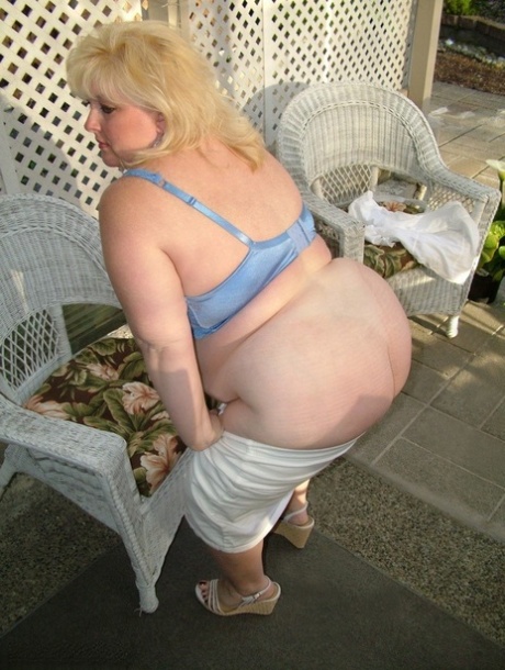 First, Taffy Spanx, who is blonde but overweight, goes for nudeness on a patio and then begins to plead her breasts.