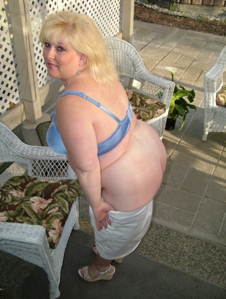 Taffy Spanx, who is overweight and blonde, exposes herself on a patio before engaging in self-pleasure.