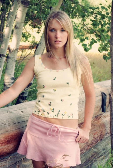 At a stand of birch trees, the lovely blonde Jewel displays her tits and buttocks.