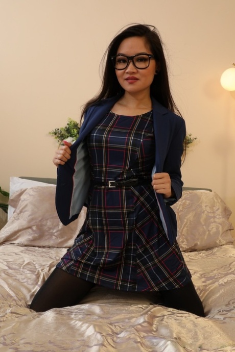 Louisa Lu of Only Opaques wearing plaid minidress, black high heels.