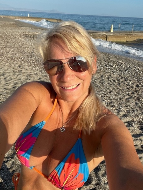 When she's not wearing clothes and only wants to be, Sweet Susi releases her natural tits and moves out of a bikini. She is a middle-aged blonde.