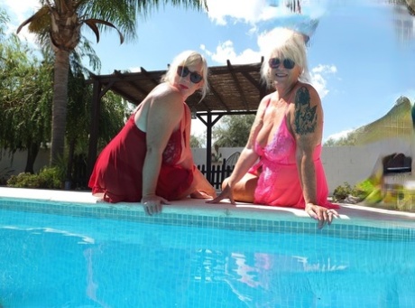 Melody, an older blonde who is overweight and lesbian, kisses her girlfriend while swimming near a pool.