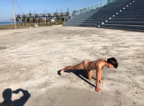 For her initial attempt at swimming, Malika goes completely naked on a concrete platform close to the water.