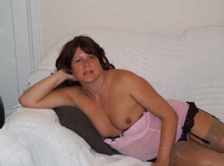 The pussy of mature brunette Cassandra Uk is stimulated while wearing lingerie.