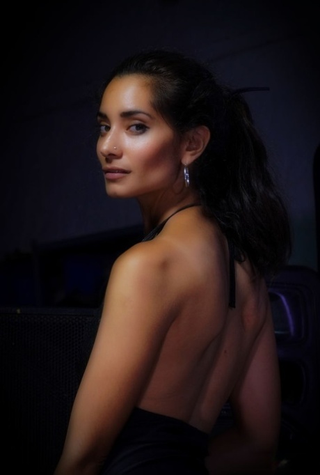 Solange, a stunning Hispanic beauty, is enjoying some alone time in the backstage area.