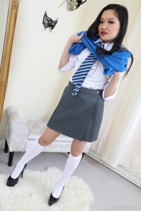 Louisa Lu from Only Tease donning a college attire consisting of high-heeled heels and white knee socks.