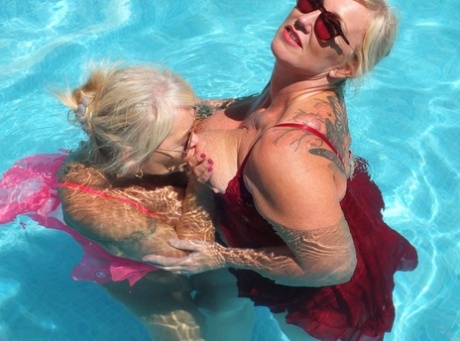 Lesbian activity: Melody, an older blonde and fatty, plays with girls in a swimming pool.
