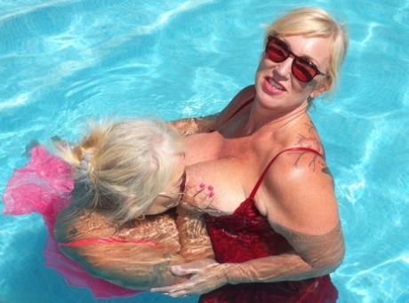 At a swimming pool table, Melody engages in lesbian play while being an older blonde and overweight.