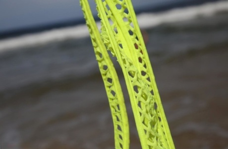 When alone on the beach, a woman removes her swimsuit while wearing only her buttocks.