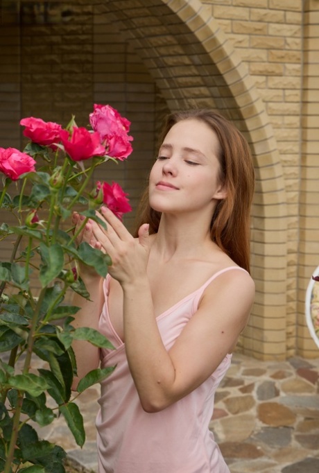 Flexible teen Nicole sniffs some roses before getting totally naked