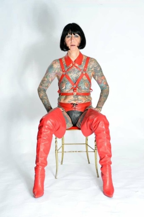 Solo Girl Tattoogirl Cleo Models A Bondage Harness In Thigh-high Boots