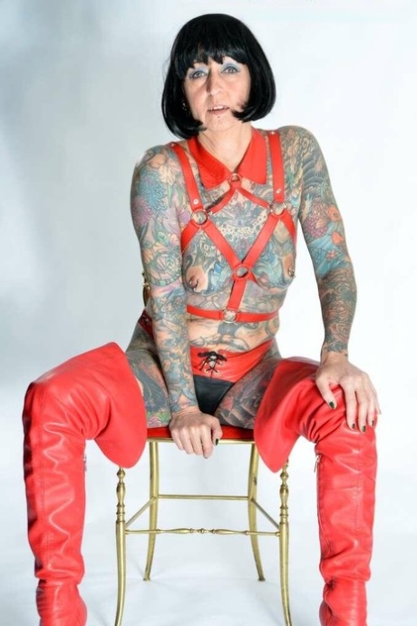 Solo Girl Tattoogirl Cleo Models A Bondage Harness In Thigh-high Boots