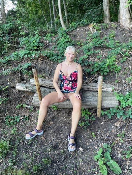 Blonde lady Sweet Susi bares herself on the water's edge during adventures along the lake.