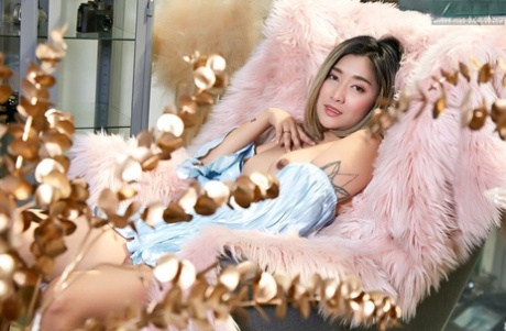 Asian beauty Apple releases her natural pussy during a solo performance.