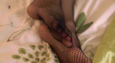In a garter belt and mesh stockings, Leah goes from being the first to attempt a naked experience on a bed.
