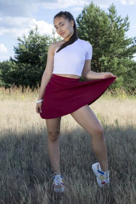 Adorable girl: Bella gets completely naked on a blanket in the middle of nature while playing in a field.