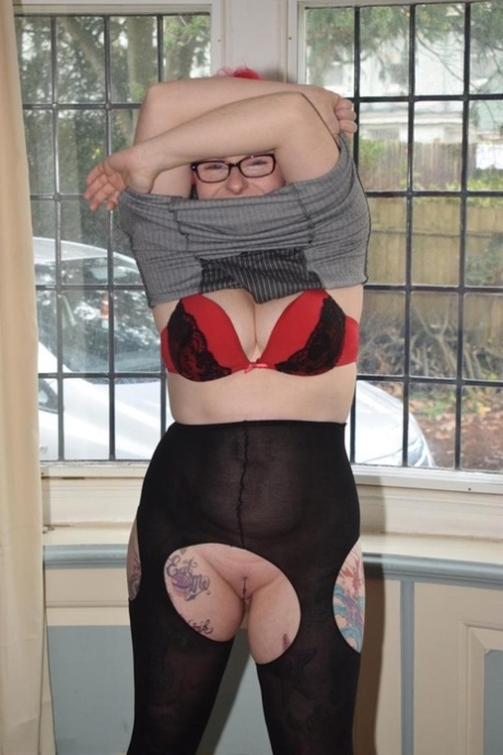 Overweight Redhead Gets Naked While Wearing Glasses And Crotchless Pantyhose