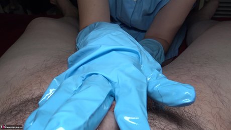 Mature Woman Hot MILF Oils Up A Cock While Wearing Blue Latex Gloves