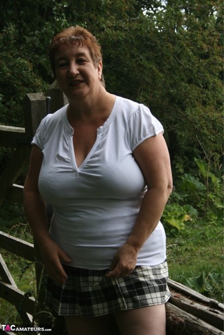 Fat British Lady Kinky Carol Unleashes Her Large Breasts Over A Rustic Fence