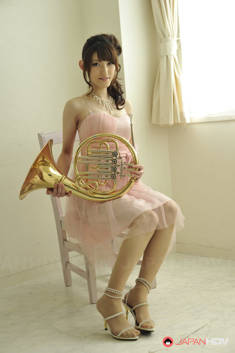 Gorgeous Japanese Girl Kanako Iioka Holds A French Horn While Getting Naked